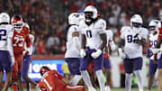 Nov 22, 2025; Houston, Texas, USA; TCU Horned Frogs defensive lineman Zachary Chapman (0) reacts after making a tackle on Houston Cougars quarterback Conner Weigman (1) during the fourth quarter at TDECU Stadium. Mandatory Credit: Troy Taormina-Imagn Images