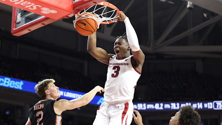 Nov 18, 2024; Fayetteville, Arkansas, USA; Arkansas Razorbacks forward Adou Thiero (3) dunks the ball in the second half as Pacific Tigers forward Elias Ralph (2) defends at Bud Walton Arena. Arkansas won 91-72. Mandatory Credit: Nelson Chenault-Imagn Images