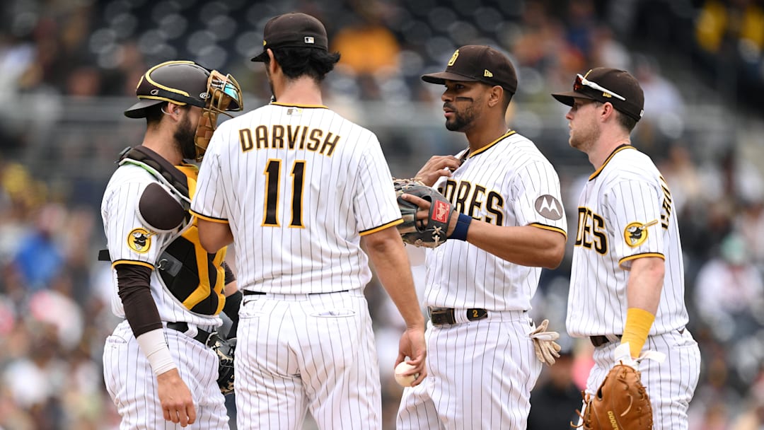 San Diego Padres starting pitcher Yu Darvish (11) meets at the mound with catcher Austin Nola (left), shortstop Xander Bogaerts (2) and first baseman Jake Cronenworth (right) during the fifth inning against the Kansas City Royals at Petco Park on May 17, 2023.