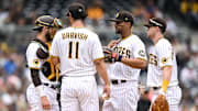 San Diego Padres starting pitcher Yu Darvish (11) meets at the mound with catcher Austin Nola (left), shortstop Xander Bogaerts (2) and first baseman Jake Cronenworth (right) during the fifth inning against the Kansas City Royals at Petco Park on May 17, 2023.