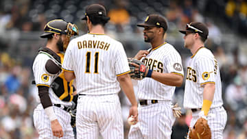 San Diego Padres starting pitcher Yu Darvish (11) meets at the mound with catcher Austin Nola (left), shortstop Xander Bogaerts (2) and first baseman Jake Cronenworth (right) during the fifth inning against the Kansas City Royals at Petco Park on May 17, 2023.