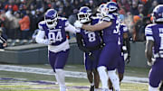 Nov 30, 2024; Chicago, Illinois, USA; Northwestern Wildcats defensive back Devin Turner (8) celebrates after he returns an interception for a touchdown against Illinois Fighting Illini during the first half at Wrigley Field. Mandatory Credit: Matt Marton-Imagn Images