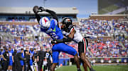 Nov 22, 2025; Dallas, Texas, USA; SMU Mustangs wide receiver Jordan Hudson (2) catches a pass for a touchdown over Louisville Cardinals defensive back Jabari Mack (4) during the first half at Gerald J. Ford Stadium. Mandatory Credit: Jerome Miron-Imagn Images