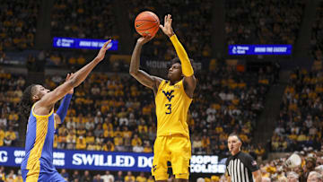 Nov 13, 2025; Morgantown, West Virginia, USA; West Virginia Mountaineers guard Honor Huff (3) shoots a three pointer over Pittsburgh Panthers guard Omari Witherspoon (8) during the second half at WVU Coliseum. Mandatory Credit: Ben Queen-Imagn Images