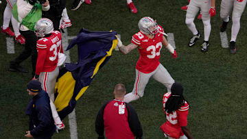 Ohio State Buckeyes defensive end Jack Sawyer (33) throws a Michigan flag take from opposing players at midfield following Saturday’s NCAA Division I at Ohio Stadium, a 13-10 win for the Wolverines.