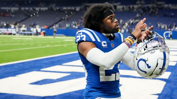 Colts cornerback Kenny Moore II (blue and white uniform) signals to fans after securing a home victory.
