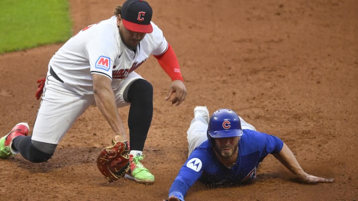 Aug 14, 2024; Cleveland, Ohio, USA; Chicago Cubs first baseman Michael Busch (29) dives safely to first base beside Cleveland Guardians first baseman Josh Naylor (22) on a pickoff attempt in the sixth inning at Progressive Field. Mandatory Credit: David Richard-USA TODAY Sports