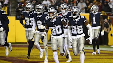 Jan 7, 2024; Landover, Maryland, USA; Dallas Cowboys cornerback DaRon Bland (26) celebrates after intercepting a pass against the Washington Commanders during the second half at FedExField. Mandatory Credit: Brad Mills-Imagn Images