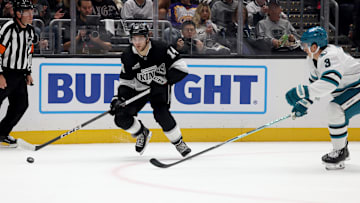Oct 24, 2024; Los Angeles, California, USA; Los Angeles Kings right wing Alex Laferriere (14) looks to pass against San Jose Sharks defenseman Henry Thrun (3) during the second period at Crypto.com Arena. Mandatory Credit: Jason Parkhurst-Imagn Images