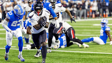Houston Texans running back Woody Marks (27) runs with the ball for a touchdown in front of Detroit Lions cornerback Rock Ya-Sin (23) during the first half at Ford Field.
