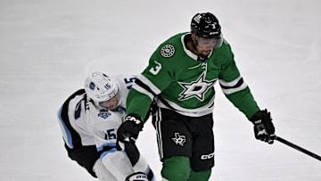 Apr 12, 2025; Dallas, Texas, USA; Dallas Stars defenseman Matt Dumba (3) keeps the puck away from Utah Hockey Club center Alexander Kerfoot (15) during the first period at the American Airlines Center. Mandatory Credit: Jerome Miron-Imagn Images