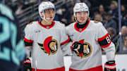 Dec 17, 2024; Seattle, Washington, USA;  Ottawa Senators forward Tim Stützle (18) is congratulated by forward Adam Gaudette (81) after scoring a goald during the third period against the Seattle Kraken at Climate Pledge Arena. Mandatory Credit: Stephen Brashear-Imagn Images