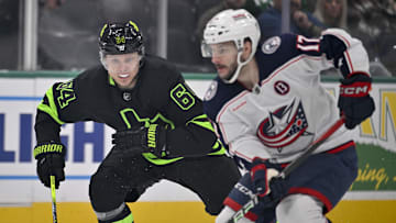 Feb 2, 2025; Dallas, Texas, USA; Dallas Stars center Mikael Granlund (64) chases Columbus Blue Jackets right wing Justin Danforth (17) during the first period at the American Airlines Center. Mandatory Credit: Jerome Miron-Imagn Images