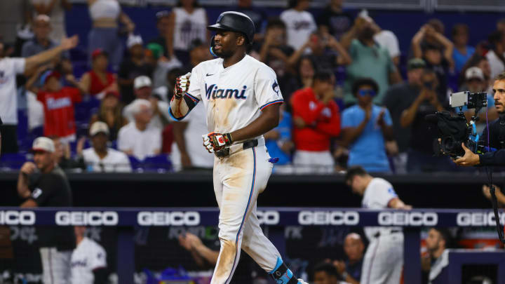 Jul 4, 2024; Miami, Florida, USA; Miami Marlins right fielder Jesus Sanchez (12) reacts on his way to home plate after hitting a two-run home run against the Boston Red Sox during the eleventh inning at loanDepot Park.