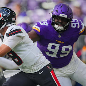 Aug 9, 2025; Minneapolis, Minnesota, USA; Houston Texans quarterback Graham Mertz (18) evades Minnesota Vikings defensive end Elijah Williams (99) in the fourth quarter at U.S. Bank Stadium.