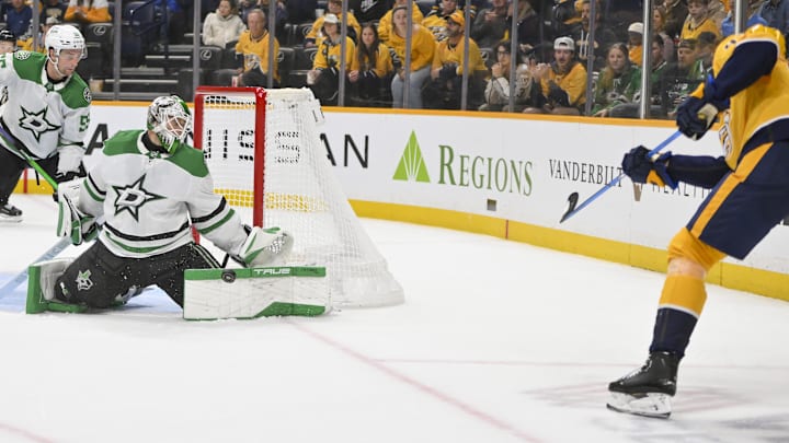 Oct 26, 2025; Nashville, Tennessee, USA;  Dallas Stars goaltender Casey Desmith (1) blocks the shot of Nashville Predators right wing Michael McCarron (47) during the third period at Bridgestone Arena. Mandatory Credit: Steve Roberts-Imagn Images