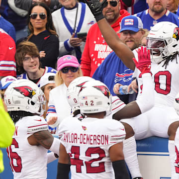 Sep 8, 2024; Orchard Park, New York, USA; Arizona Cardinals running back DeeJay Dallas (20) celebrates scoring a touchdown with teammates during the second half against the Buffalo Bills at Highmark Stadium. Mandatory Credit: Gregory Fisher-Imagn Images