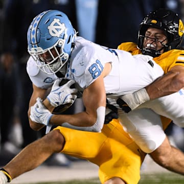 Cal linebacker Cade Uluave tackles a North Carolina receiver