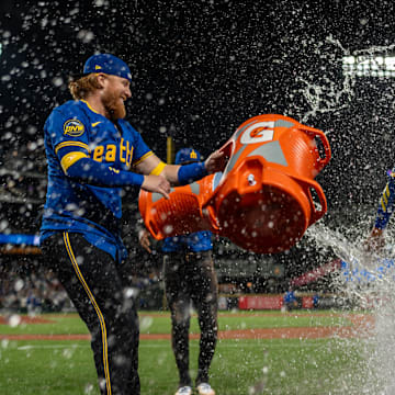 Seattle Mariners designated hitter Justin Turner (2), left, and right fielder Victor Robles (10), second from left, douse centerfielder Julio Rodriguez (44) with water after a game against the Texas Rangers at T-Mobile Park on Sept 13.