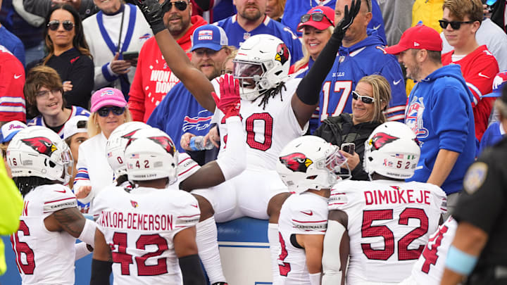 Sep 8, 2024; Orchard Park, New York, USA; Arizona Cardinals running back DeeJay Dallas (20) celebrates scoring a touchdown with teammates during the second half against the Buffalo Bills at Highmark Stadium. Mandatory Credit: Gregory Fisher-Imagn Images