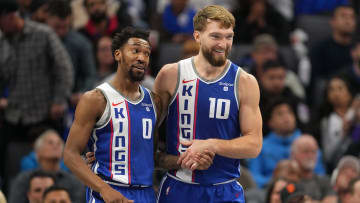 Dec 4, 2023; Sacramento, California, USA; Sacramento Kings guard Malik Monk (0) talks with forward Domantas Sabonis (10) during the second quarter against the New Orleans Pelicans at Golden 1 Center. Mandatory Credit: Darren Yamashita-USA TODAY Sports