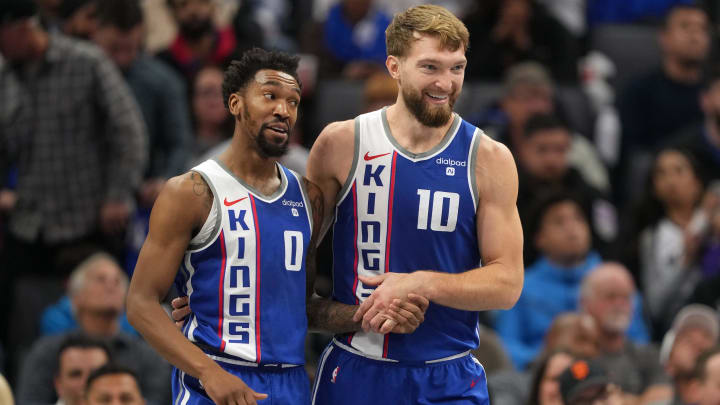 Dec 4, 2023; Sacramento, California, USA; Sacramento Kings guard Malik Monk (0) talks with forward Domantas Sabonis (10) during the second quarter against the New Orleans Pelicans at Golden 1 Center. Mandatory Credit: Darren Yamashita-USA TODAY Sports