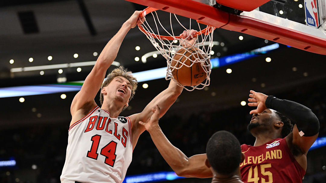 Oct 9, 2025; Chicago, Illinois, USA; Chicago Bulls forward Matas Buzelis (14) dunks against Cleveland Cavaliers guard Donovan Mitchell (45) and forward Evan Mobley (4) during the second half at United Center. Mandatory Credit: Patrick Gorski-Imagn Images