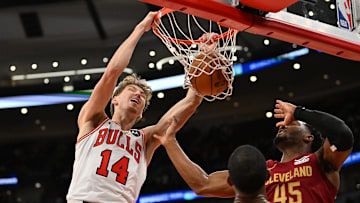 Oct 9, 2025; Chicago, Illinois, USA; Chicago Bulls forward Matas Buzelis (14) dunks against Cleveland Cavaliers guard Donovan Mitchell (45) and forward Evan Mobley (4) during the second half at United Center. Mandatory Credit: Patrick Gorski-Imagn Images