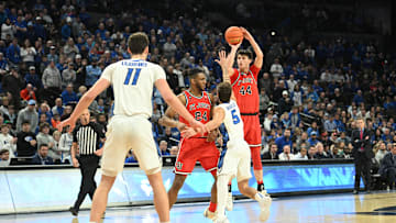 Jan 13, 2024; Omaha, Nebraska, USA;  St. John's basketball forward Brady Dunlap (44) shoots over Creighton Bluejays guard Francisco Farabello (5) in the first half at CHI Health Center Omaha. Mandatory Credit: Steven Branscombe-Imagn Images