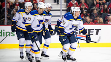 Dec 5, 2024; Calgary, Alberta, CAN; St. Louis Blues center Zachary Bolduc (76) celebrates with left wing Brandon Saad (20), center Brayden Schenn (10) and teammates after scoring a goal against the Calgary Flames during the first period at Scotiabank Saddledome. Mandatory Credit: Brett Holmes-Imagn Images