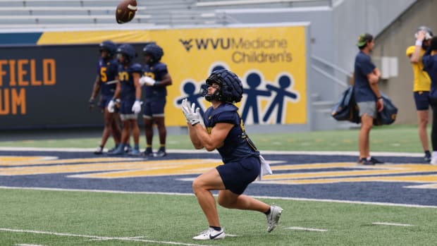 West Virignia receiver Tyler Eveans fielding a punt during fall camp.