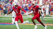 Sep 23, 2023; Lawrence, Kansas, USA; Kansas Jayhawks cornerback Cobee Bryant (2) celebrates with cornerback Mello Dotson (3) after an interception against the Brigham Young Cougars during the second half at David Booth Kansas Memorial Stadium. Mandatory Credit: Jay Biggerstaff-USA TODAY Sports