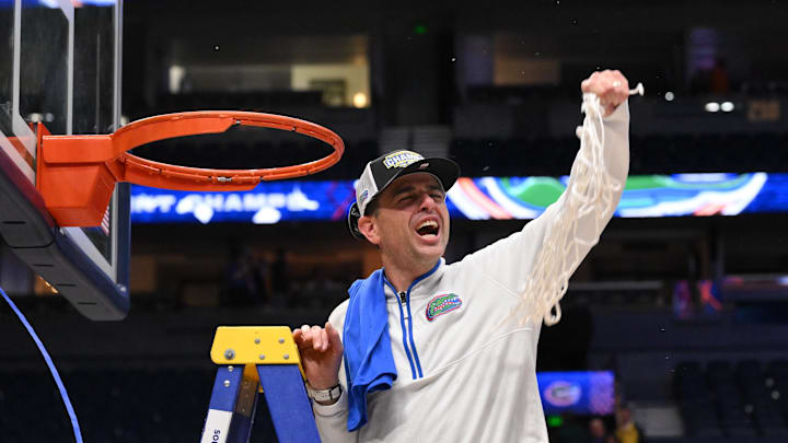 Mar 16, 2025; Nashville, TN, USA; Florida Gators head coach Todd Golden cuts the net after winning the 2025 SEC Championship Game at Bridgestone Arena. Mandatory Credit: Steve Roberts-Imagn Images