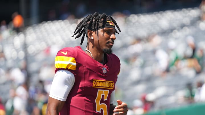 Aug 10, 2024; East Rutherford, New Jersey, USA; Washington Commanders quarterback Jayden Daniels (5) warms up before the game against the New York Jets at MetLife Stadium. Mandatory Credit: Lucas Boland-USA TODAY Sports