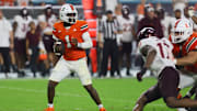 Sep 27, 2024; Miami Gardens, Florida, USA; Miami Hurricanes quarterback Cam Ward (1) looks for a passing option against the Virginia Tech Hokies during the fourth quarter at Hard Rock Stadium. Mandatory Credit: Sam Navarro-Imagn Images