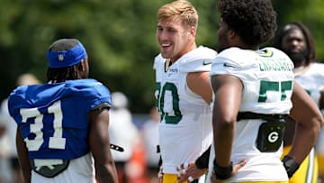 Indianapolis Colts running back Tyler Goodson (31) greets Green Bay Packers defensive linemen Lukas Van Ness (90) and Kingsley Enagbare (55) on Thursday, Aug. 14, 2025, ahead of a joint practice during Indianapolis Colts’ training camp at Grand Park in Westfield.