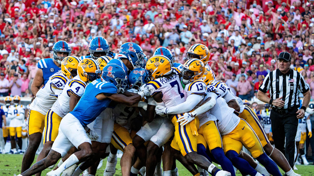 LSU players swarm the Ole Miss offense during a college football game between Ole Miss and LSU at Vaught-Hemingway Stadium in Oxford, Miss., on Saturday, Sept. 27, 2025. Ole Miss defeated LSU 24-19.