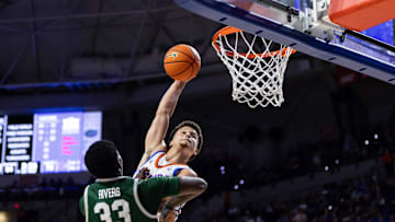 Nov 7, 2024; Gainesville, Florida, USA; Florida Gators guard Walter Clayton Jr. (1) dunks against Jacksonville Dolphins forward Donovan Rivers (33) during the second half at Exactech Arena at the Stephen C. O'Connell Center. Mandatory Credit: Matt Pendleton-Imagn Images