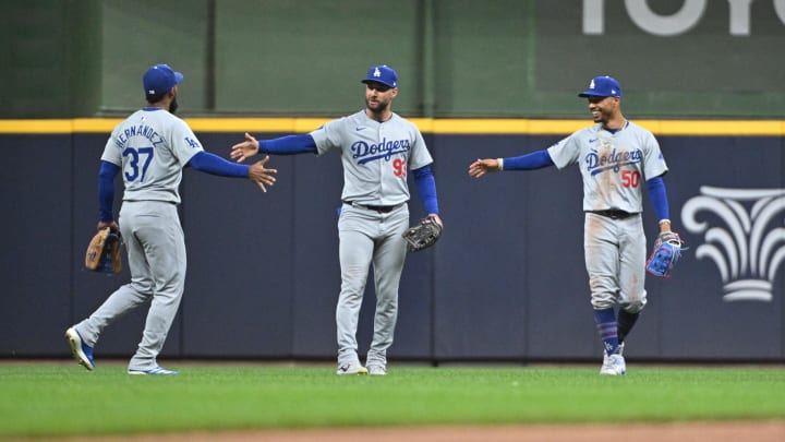 Aug 12, 2024; Milwaukee, Wisconsin, USA; Los Angeles Dodgers outfielder Teoscar Hernández (37), Los Angeles Dodgers outfielder Kevin Kiermaier (93) and Los Angeles Dodgers outfielder Mookie Betts (50) celebrate a 5-2 win over the Milwaukee Brewers at American Family Field. Mandatory Credit: Michael McLoone-USA TODAY Sports