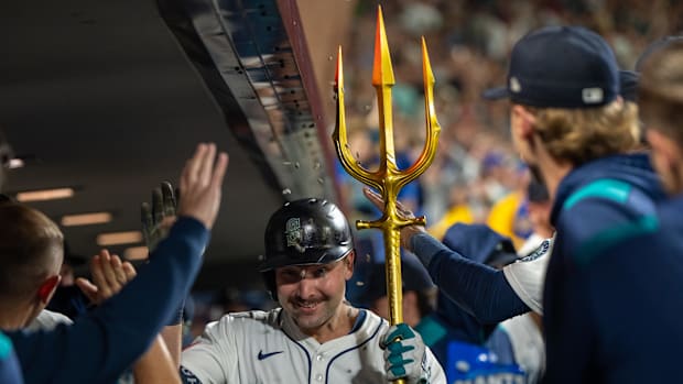 Seattle Mariners catcher Cal Raleigh celebrates in the dugout after hitting a solo home run.