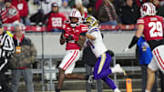 Nov 8, 2025; Madison, Wisconsin, USA;  Wisconsin Badgers cornerback Ricardo Hallman (2) intercepts the pass intended for Washington Huskies wide receiver Dezmen Roebuck (81) during the second quarter at Camp Randall Stadium.