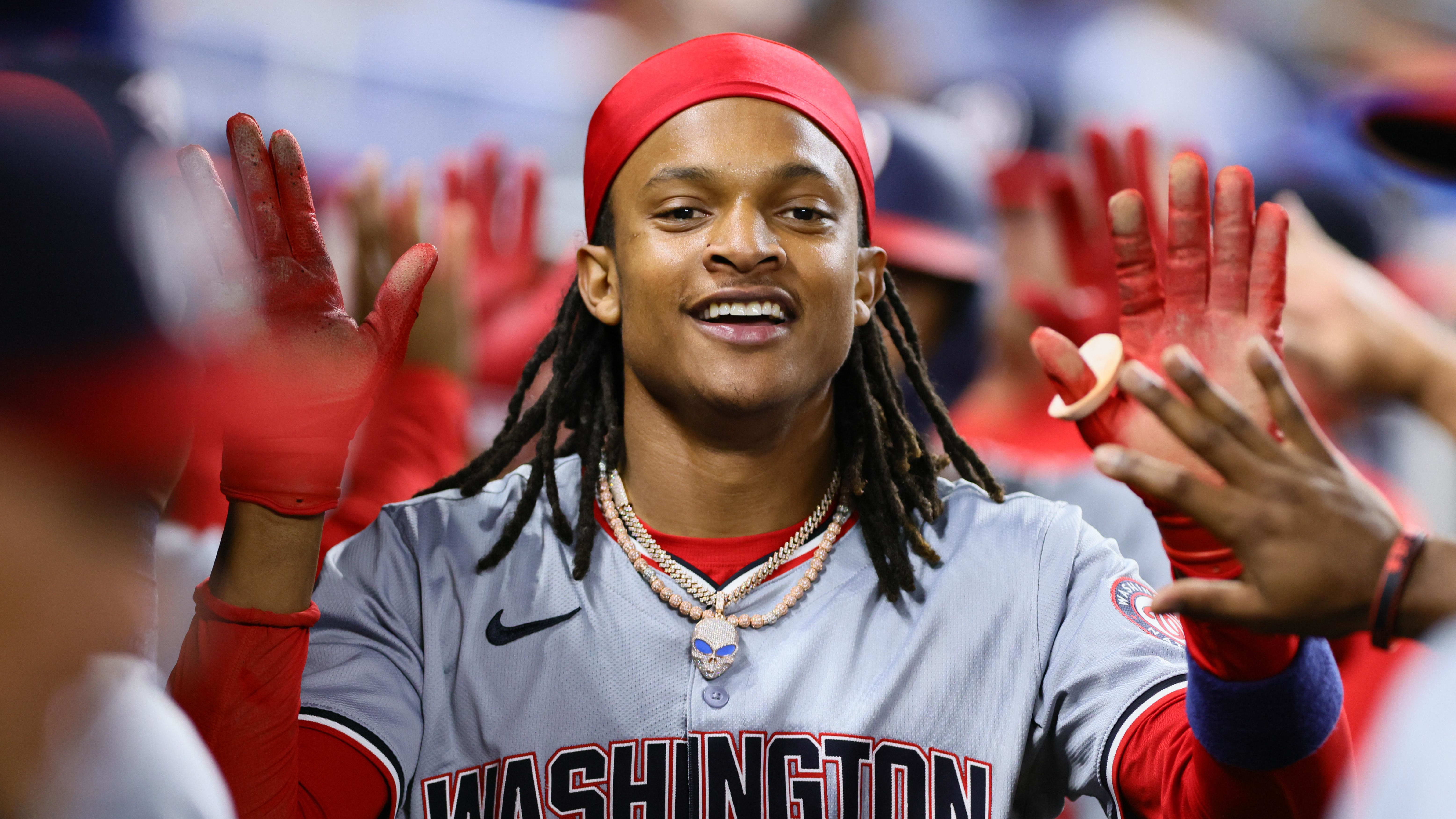 Washington Nationals shortstop CJ Abrams (5) celebrates with teammates in the dugout. 