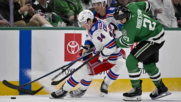 Apr 11, 2026; Dallas, Texas, USA; New York Rangers right wing Gabe Perreault (94) and Dallas Stars left wing Jason Robertson (21) battle for control of the puck during the third period at the American Airlines Center. Apr 11, 2026; Dallas, Texas, USA; New York Rangers right wing Gabe Perreault (94) and Dallas Stars left wing Jason Robertson (21) battle for control of the puck during the third period at the American Airlines Center.