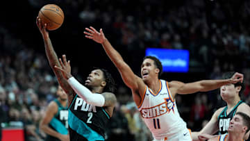 Portland Trail Blazers guard Caleb Love (2) drives to the basket past Phoenix Suns big man Oso Ighodaro (11) during the first half at Moda Center. Mandatory Credit: Soobum Im-Imagn Images