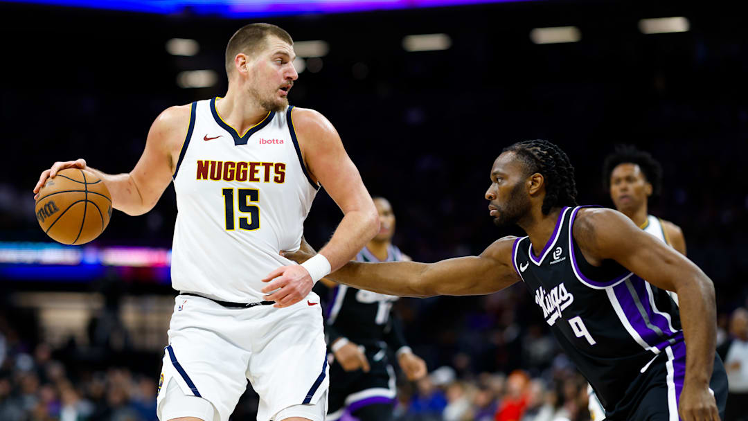 Dec 11, 2025; Sacramento, California, USA; Denver Nuggets center Nikola Jokic (15) dribbles the ball against Sacramento Kings forward Precious Achiuwa (9) during the third quarter at Golden 1 Center. Mandatory Credit: Sergio Estrada-Imagn Images