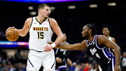 Dec 11, 2025; Sacramento, California, USA; Denver Nuggets center Nikola Jokic (15) dribbles the ball against Sacramento Kings forward Precious Achiuwa (9) during the third quarter at Golden 1 Center. Mandatory Credit: Sergio Estrada-Imagn Images