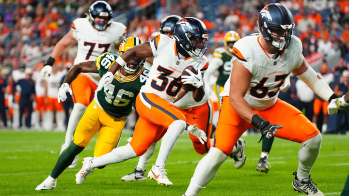 Aug 18, 2024; Denver, Colorado, USA; Denver Broncos running back Tyler Badie (36) runs for a touchdown in the fourth quarter against the Green Bay Packers  at Empower Field at Mile High. 