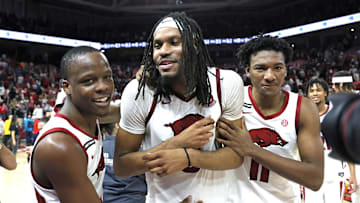 Mar 8, 2025; Fayetteville, Arkansas, USA; Arkansas Razorbacks guard Johnell Davis (1) celebrates with forwards Jonas Aidoo (9) and Karter Knox (11) after the game against the Mississippi State Bulldogs at Bud Walton Arena. Arkansas won 93-92. Mandatory Credit: Nelson Chenault-Imagn Images