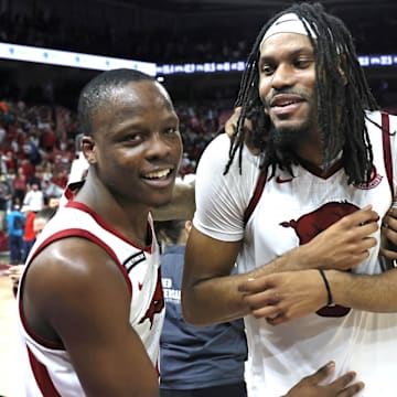  Arkansas Razorbacks guard Johnell Davis (1) celebrates with forwards Jonas Aidoo (9) and Karter Knox (11) after the game against the Mississippi State Bulldogs at Bud Walton Arena. Arkansas won 93-92. 