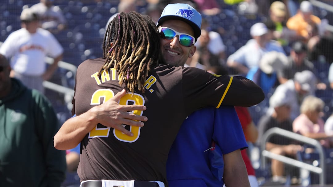 Mar 4, 2024; Peoria, Arizona, USA; San Diego Padres right fielder Fernando Tatis Jr. (23) and Chicago Cubs coach Ryan Flaherty meet before a game at Peoria Sports Complex. Mandatory Credit: Rick Scuteri-Imagn Images